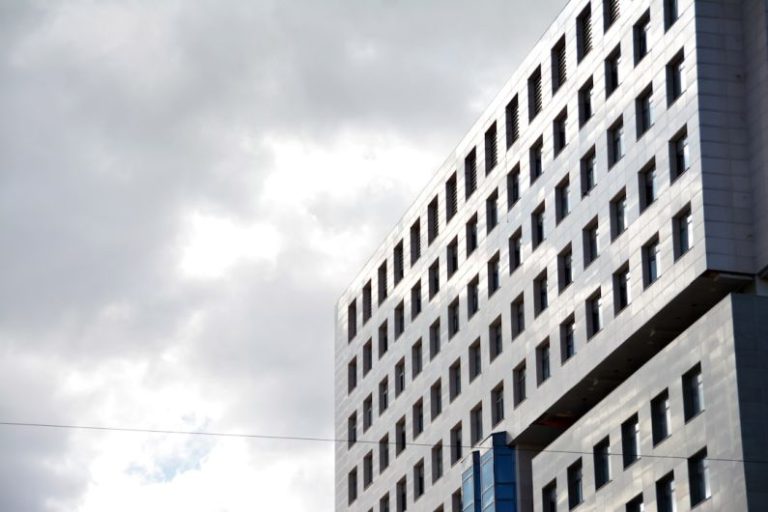 Innovative Materials - a tall building with many windows and a sky background