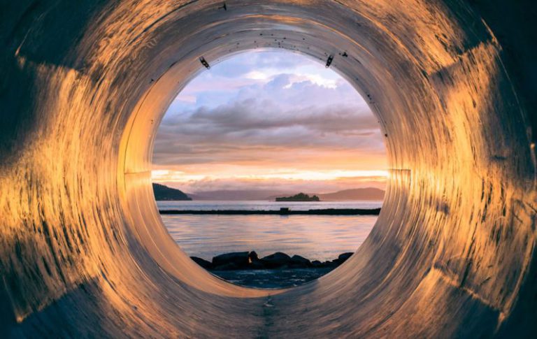 Circular Economy - body of water can be seen through the tunnel