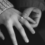 Next Generation Engagement - woman wearing wedding ring with man holding hand
