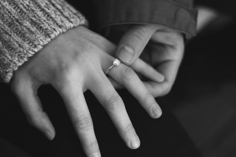 Next Generation Engagement - woman wearing wedding ring with man holding hand