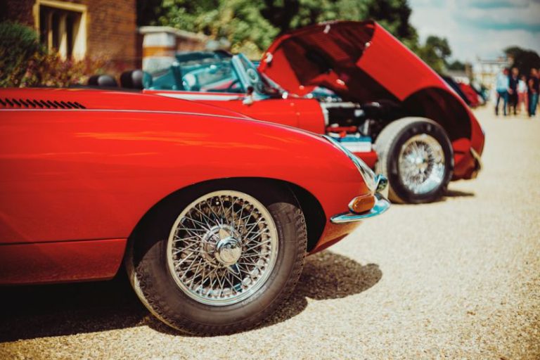 Tire Types - red ferrari car on brown sand during daytime