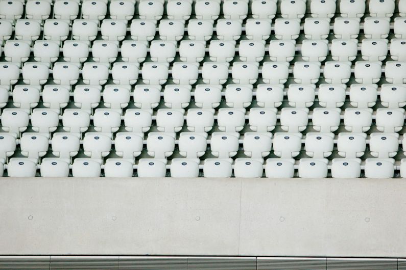 Multiple Retreads - white seats with gray concrete platform