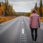Suitability Check - person standing on middle of blacktop road during daytime