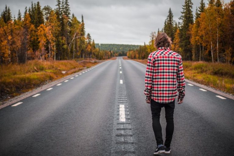Suitability Check - person standing on middle of blacktop road during daytime