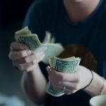 Commercial Fleets - focus photography of person counting dollar banknotes