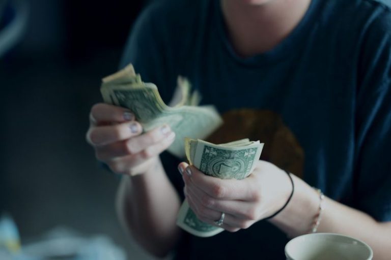Commercial Fleets - focus photography of person counting dollar banknotes
