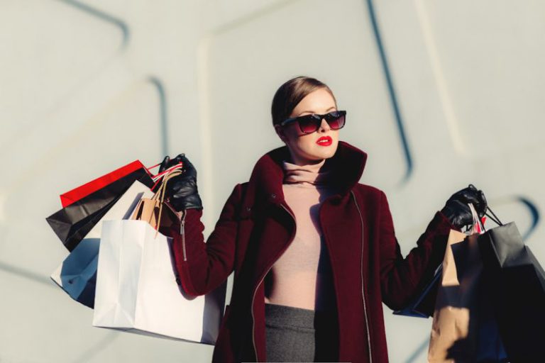Material Trends - photo of woman holding white and black paper bags