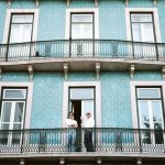 Bonding Agents - two men standing on black railings in blue concrete building