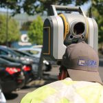 Laser Scanning - man looking at device on road