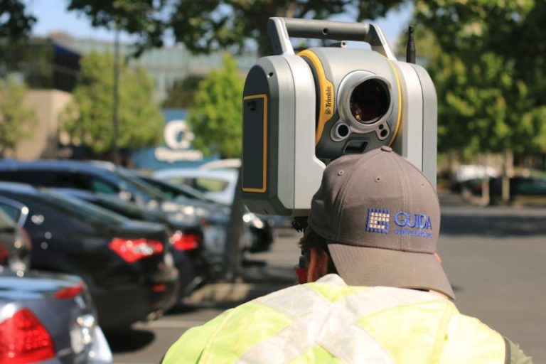Laser Scanning - man looking at device on road