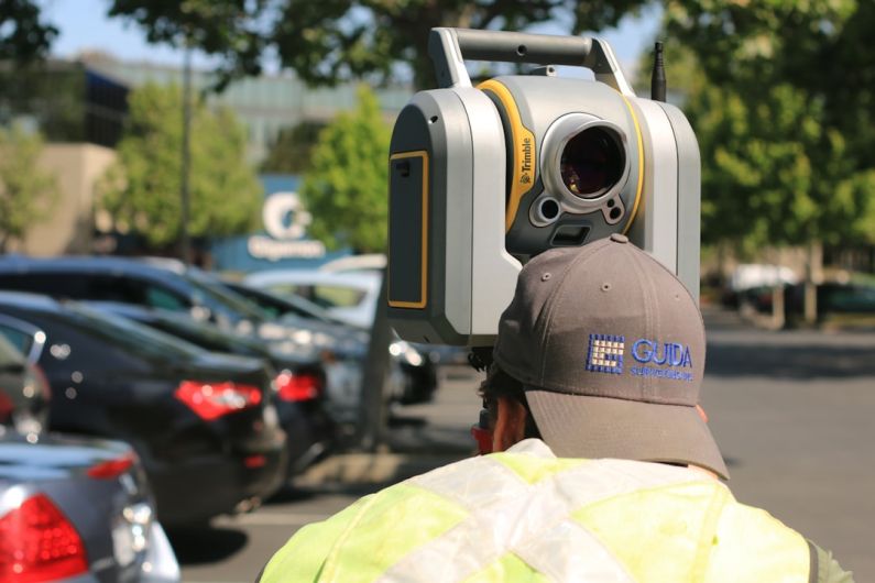 Laser Scanning - man looking at device on road