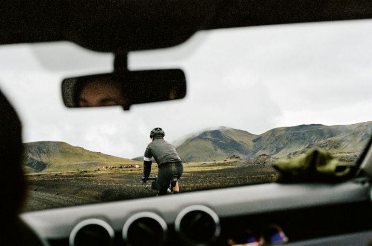 Driving Habits - a man riding a bike down a dirt road