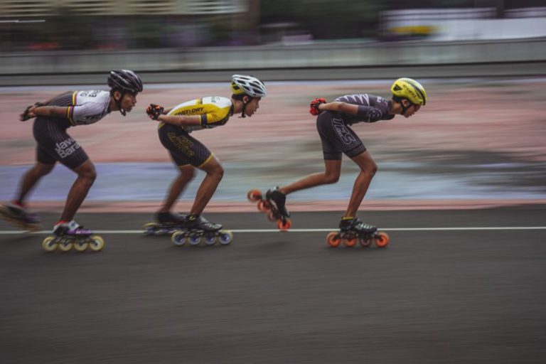 High-speed Tips - man in blue tank top and yellow helmet riding on orange and black motorcycle