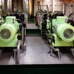Fuel Efficiency - a couple of green machines sitting inside of a building