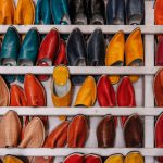 Demand Reduction - assorted-color shoe lot on white wooden shelf