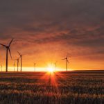 Renewable Synergy - windmill on grass field during golden hour