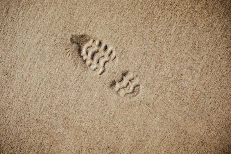 Ecological Footprint - selective focus photography of foot print