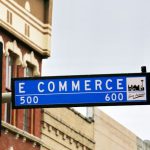 E-commerce - a traffic light with a street sign hanging from it's side