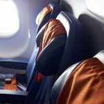 Passenger Resurgence - black leather airplane seat beside window
