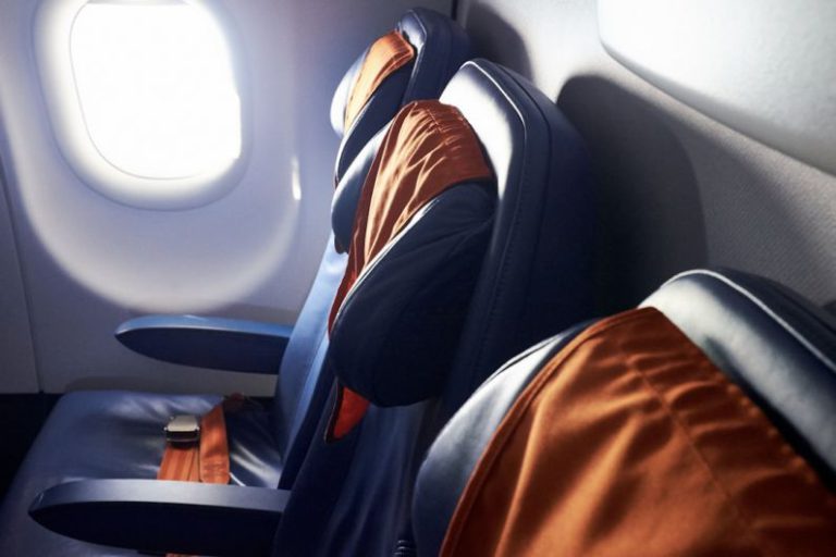 Passenger Resurgence - black leather airplane seat beside window