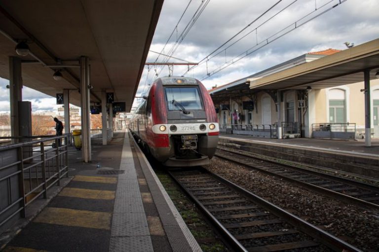 Sustainability Edge - a red and white train pulling into a train station