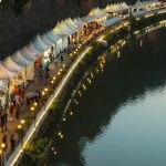 Niche Markets - white canopy with stores near body of water during daytime