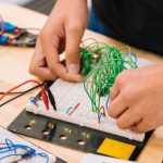 Consumer Education - person holding black and white audio mixer